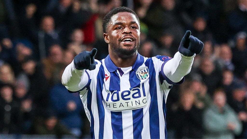 West Brom striker Josh Maja celebrates with his arms stretched out in front of him.