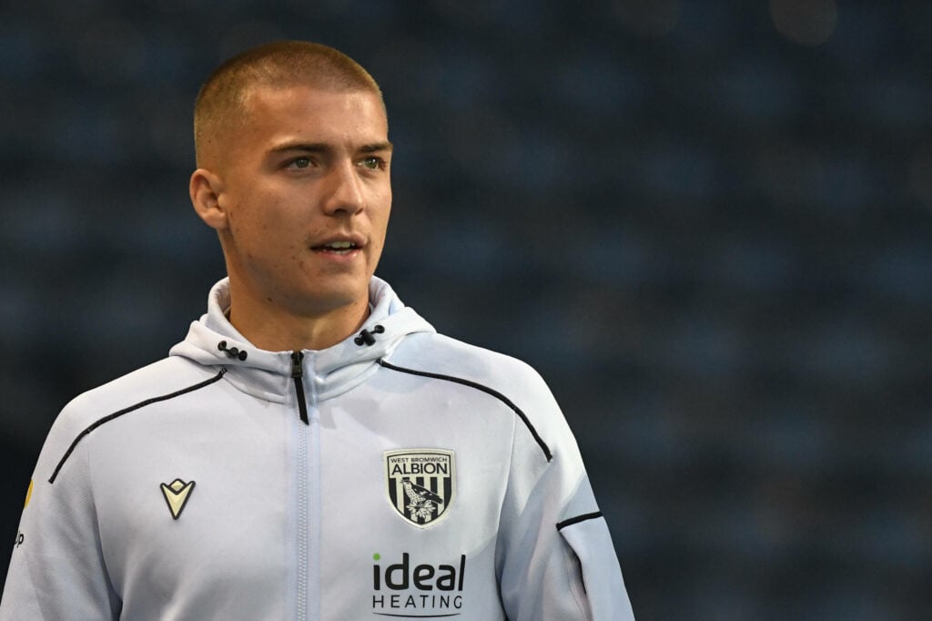 West Brom defender Alfie Gilchrist arrives at a game wearing a club tracksuit.