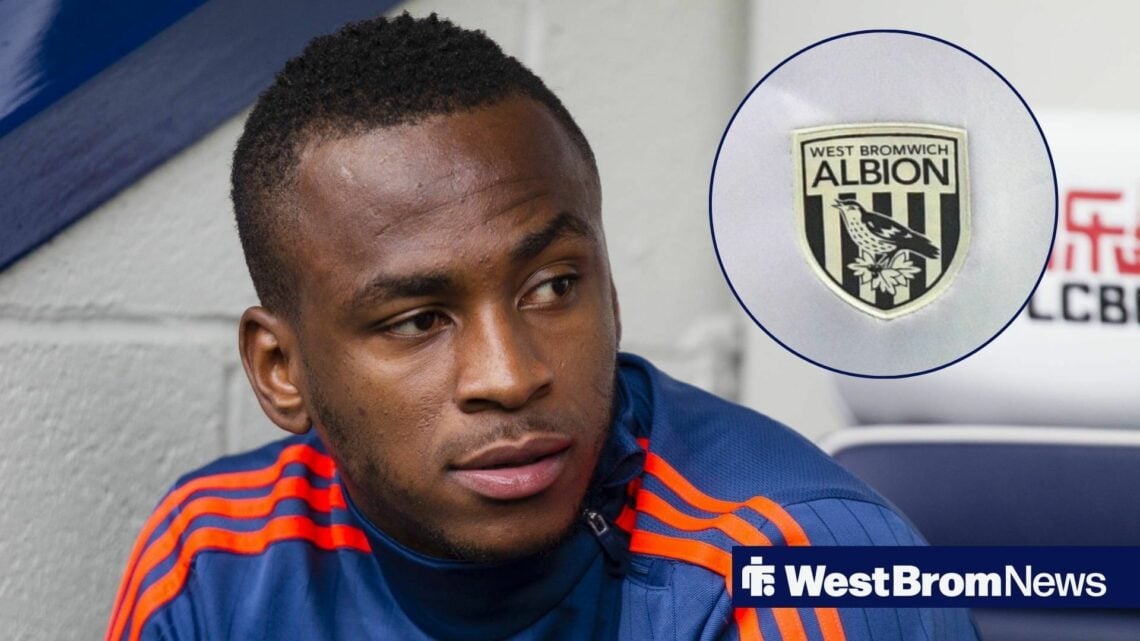 Saido Berahino looking at West Brom badge.