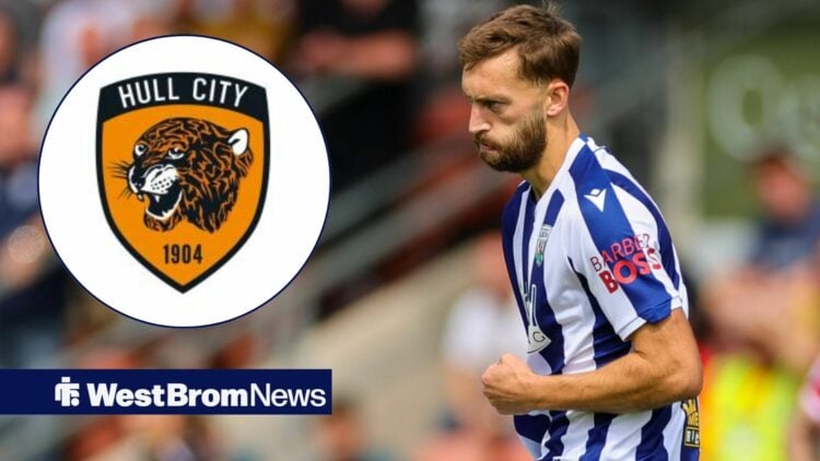 Nat Phillips looking at the Hull City badge.