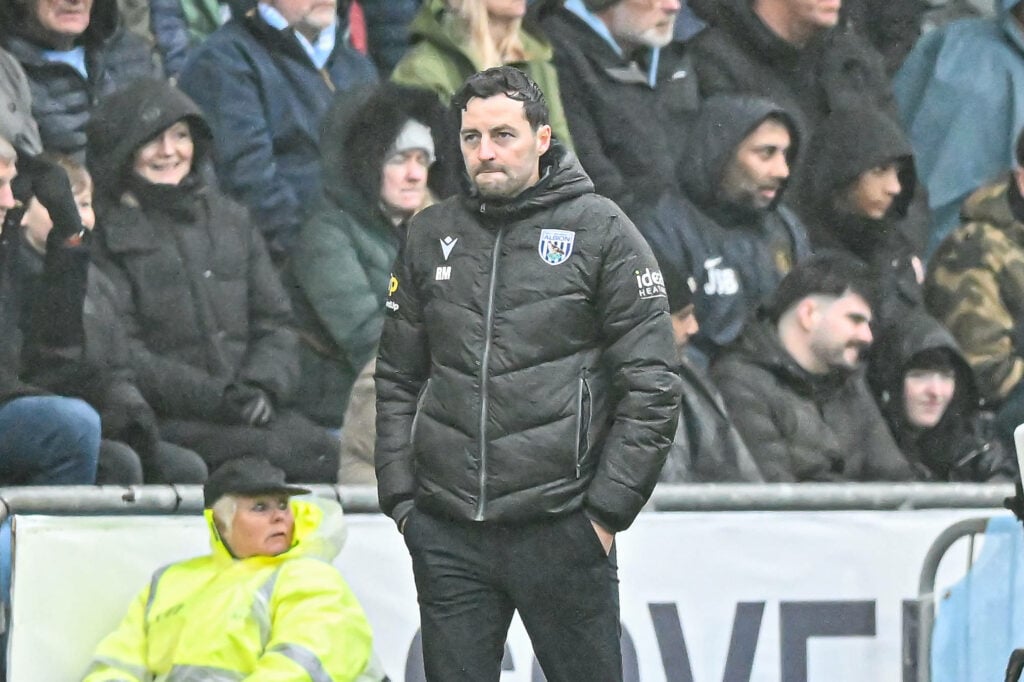 Ryan Mason standing in the rain