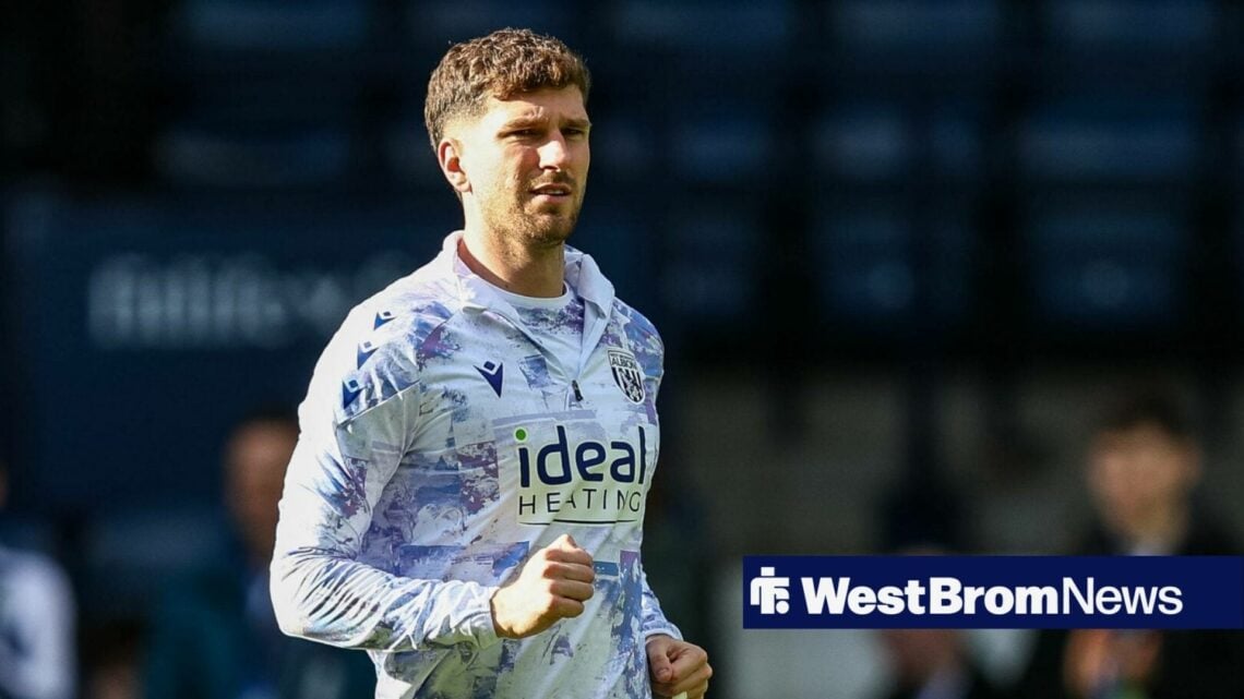 Chris Mepham jogging in a West Brom training top.