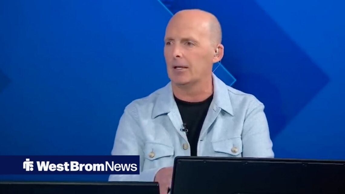 Mike Dean looking to his left.