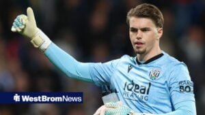 Josh Griffiths with his arm outstretched and his thumb pointed upwards.