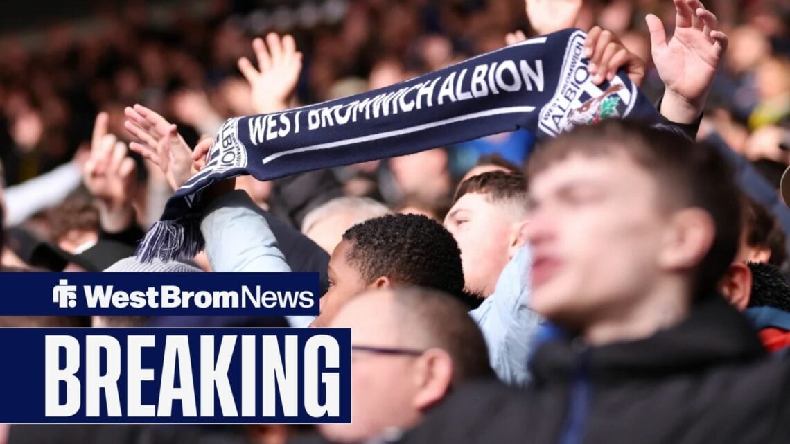 West Brom fan holding up a scarf at The Hawthorns