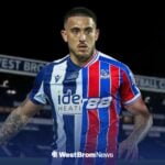 Danny Imray wearing a 50-50 shirt in the colours of West Bromwich Albion and Crystal Palace.
